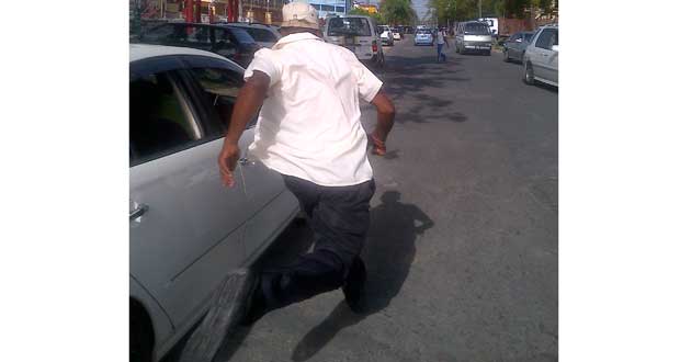 Assault accused Constable Devin Singh sprints from the Magistrates’ Court along Brickdam as he sought refuge from the media in the Brickdam Police Station. (Leroy Smith photo)