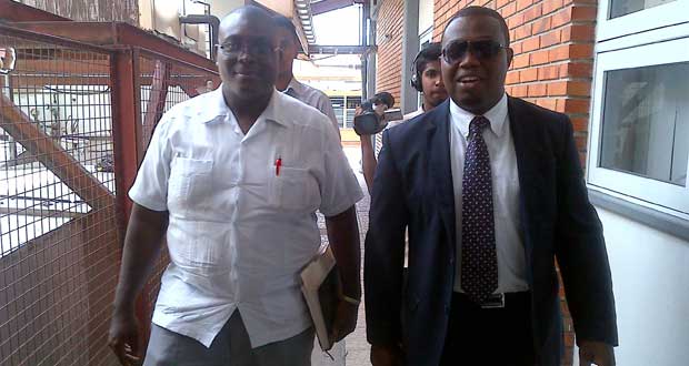 Attorney-at-Law Dexter Todd at right and a police investigator make their way to Burn Care Unit at the Georgetown Public Hospital to interview the teenager.