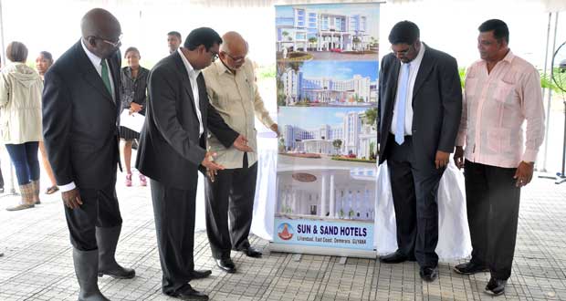 Overlooking the concept design for the Sun and Sand Hotel and Casino (from left) Director of the Sun and Sand Group of Companies, Mr. Bhushan Chandra; President Donald Ramotar, Minister of Tourism, Industry and Commerce (Ag.), Mr. Irfaan Ali; and CEO of BK International, Mr. Brian Tiwarie (Photo by Delano Williams)