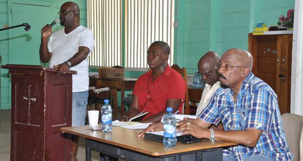 At the podium is  City Councillor, Mr. Junior Garrett, while at the head table are,  from left, the moderator of the event; Project Manager of the Georgetown Solid Waste Management Programme, Mr. Gordon Gilkes;  and Minister of Local Government and Regional Development, Mr. Norman Whittaker