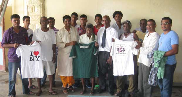 Pandit Deodat Persaud makes a presentation to a Dharm Shala inmate in the presence of group members and caretaker Gary Erskine