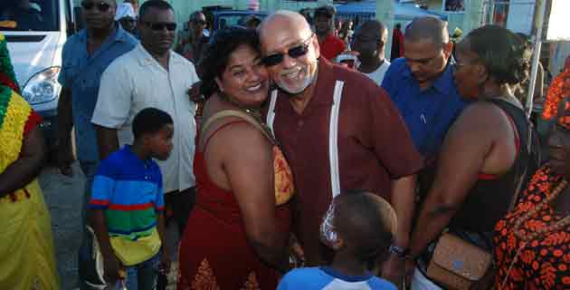 President Donald Ramotar receives a warm welcome from this young lady at the National Park yesterday as he joined thousands gathered to celebrate Emancipation Day in the traditional Guyanese style. (Cullen Bess -Nelson photo)