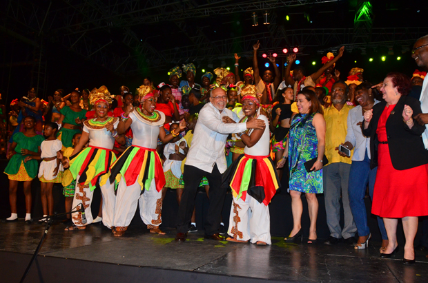 President of Guyana, Donald Ramotar enjoying a ‘festival dance’ surrounded by performing artistes. Also on stage L-R Minister of Foreign Affairs, Carolyn Rodrigues-Birkett; Prime Minister, Samuel Hinds; Minister of Public Service, Jennifer Westford and Adviser on Governance to the President, Gail Teixeira (Adrian Narine photo)
