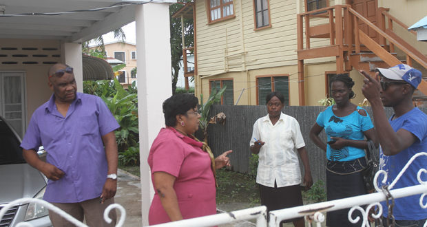 Acting Town Clerk Carol Sooba with security personnel at her residence yesterday morning
