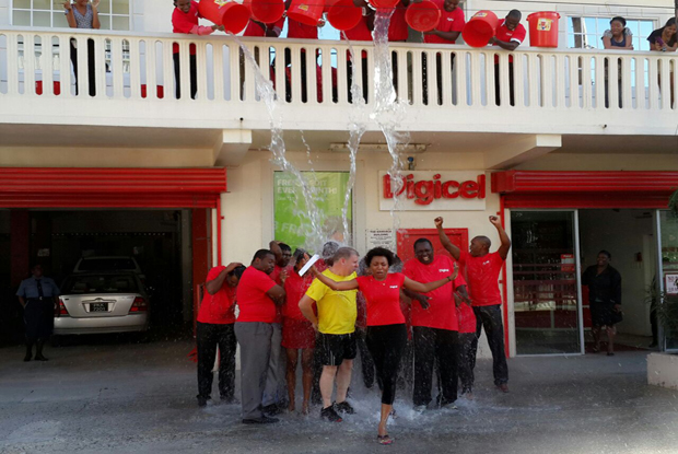 Digicel Guyana staffers being drenched with ice-cold water during the Ice Bucket Challenge on Saturday afternoon