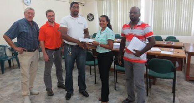 EPA’s Senior Environmental Officer, Ms. Bibi Sharief (second right) presenting contracts to IECS Representative, Mr. Deoraj Dalchand, for Supervision of the Project. Also in photo are Mr. Ben ter Welle, Team Leader, GFA Consulting Group, and Mr. Joel Breems, Protected Areas Commission Representative (first and second left); and  Project Contractor, Mr. Alvin Chowramootoo (right)