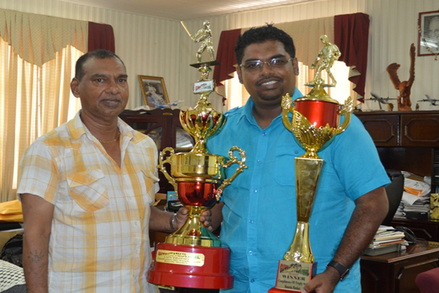 Trophy Stall’s Ramesh Sunich (left) presents the trophies to Minister of Tourism Irfaan Ali.
