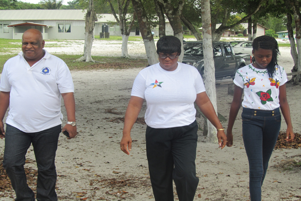 Performing the duties of Commissioner of Police, Assistant Commissioner of Police Balram Persaud is escorted into the camp chapel by Camp Mother Denise Fowler and one of the campers for the formal closing of the week-long session (Photos by Leroy Smith)