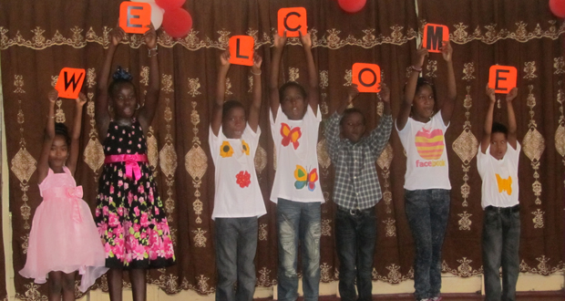 Agricola children doing a welcome acrostic for their guests on Saturday