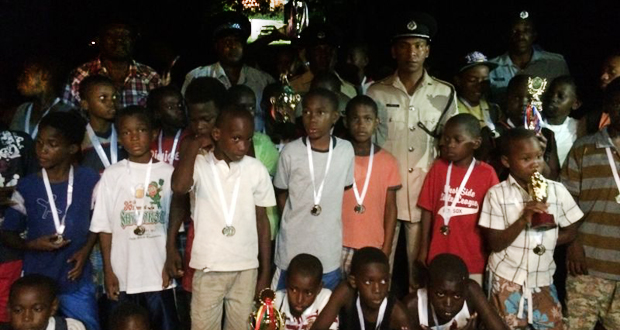Commander Brutus poses with the youths of Linden after the fun day last Sunday