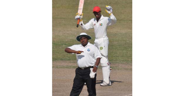 As umpire Delvin Austin signals his 10th four, Demerara batsman Amir Khan celebrates his maiden Inter-county century, after recording same as a nightwatchman against GCB Developmental XI yesterday.