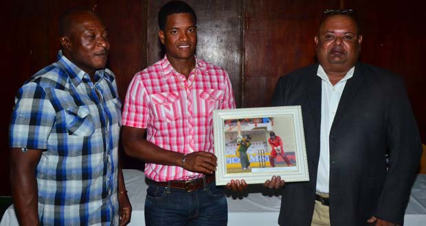 Georgetown Cricket Club’s head coach Montey Lynch (at left) shares the moment as the club’s latest West Indies Test player Leon Johnson (centre) hands over the framed picture which will be hung on the walls of the Club’s Hall of Fame, to Club president Lionel Jaikarran. (Photo by Adrian Narine)