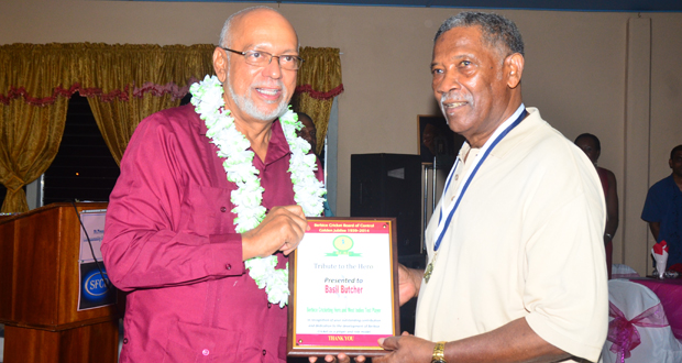 In this Adrian Narine photograph, the 80-year-old Basil Butcher (right), proudly accepts his plaque from President Donald Ramotar.