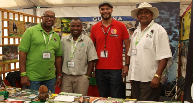 GTA Director Indranauth Haralsingh (right) and three others in the Guyana booth at the bird fair in England  