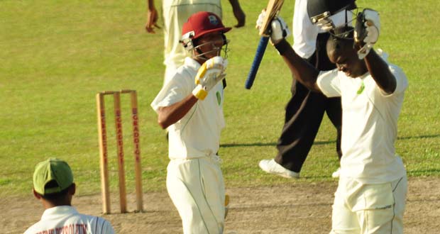 As fast bowler Kemo Paul makes his way back to his mark and with wicketkeeper Kemol Savory (left) and his teammate Gudakesh Motie-Kanhai looking on admirably, Anthony Bramble (right) salutes the crowd after reaching 150.