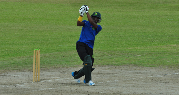 Demerara opener Trevon Griffith hits one over the top, during his robust half-century yesterday