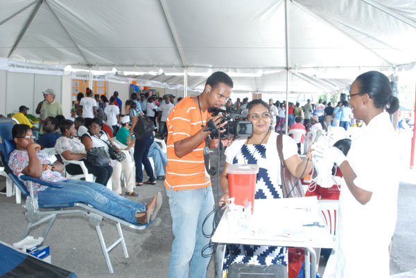 Members of a sister media house interviewing one the dentists at the fair