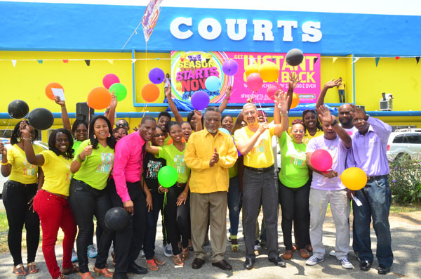 Acting President, Mr. Samuel Hinds (fifth right) joins Courts (Guyana) Managing Director, Mr. Clyde de Haas (fourth right) and other members of staff in celebrating the company’s 21st Anniversary