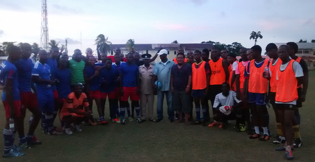 Commander of ‘A’ Division within the Guyana Police Force Clifton Hicken (centre) poses for a photo with both teams after the game.