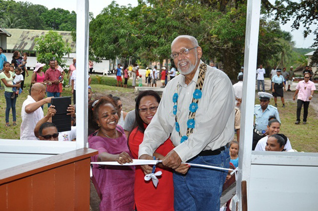 President Donald Ramotar, with the help of Minister of Amerindian Affairs, Ms. Pauline Sukhai and UNDP Country Representative, Ms. Kadijah Musa, cuts the symbolic to declare open the Santa Aratack guest-house
2: