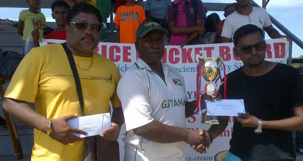 Shabeer Baksh, assistant treasurer of BCB, hands over the winning trophy and cash prize to the victorious captain, Jaipaul Heeralall of D’Edward Sports Club, in the presence of Anil Beharry, BCB’s first vice-president.