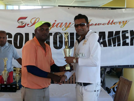 Winning rookie Mahendra Bhagwandin (left) smiles proudly as he accepts his souvenir golden golf club from Managing Director of Sanjay’s Jewellery, Sanjay Persaud after dominating last Sunday’s tournament.