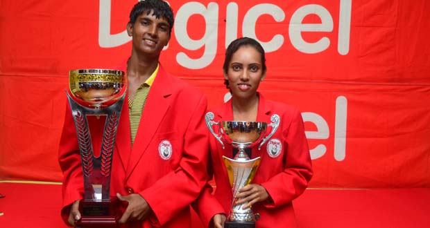 Flashback! We are the champions! Proudly decked out in their ‘Red Jackets’ 2013 Digicel Golf Open Champions Arvinda Kishore (male) and Christine Sukhram display their spoils after claiming the top prizes last year. Will this be the scene this Sunday when the action culminates. (Photo by Adrian Narine)