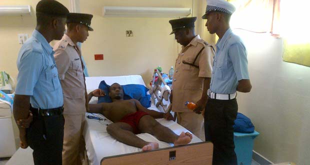 Commander Brutus, his deputy and other ranks at the bedside of the injured policeman