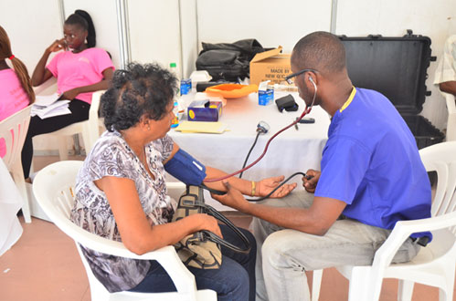 A woman having her blood pressure tested