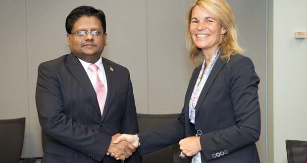 Guyana’s Minister of Finance,  Dr. Ashni Singh in a handshake with Sophie Sirtaine, Director of the Caribbean Country Management Unit of the World Bank after the signing of the agreements