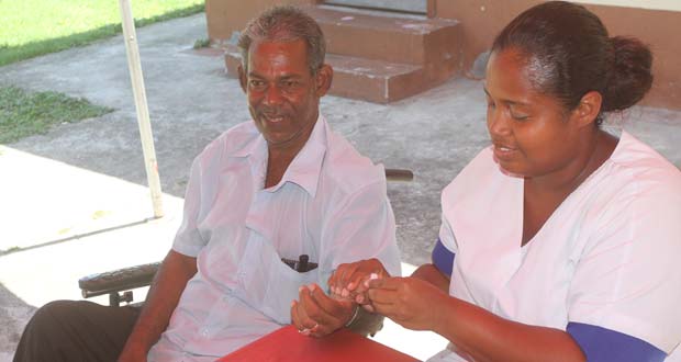 A happy elderly man; is elated because he has the opportunity to have his blood pressure tested at the mini-health fair yesterday, in the compound of The Palms