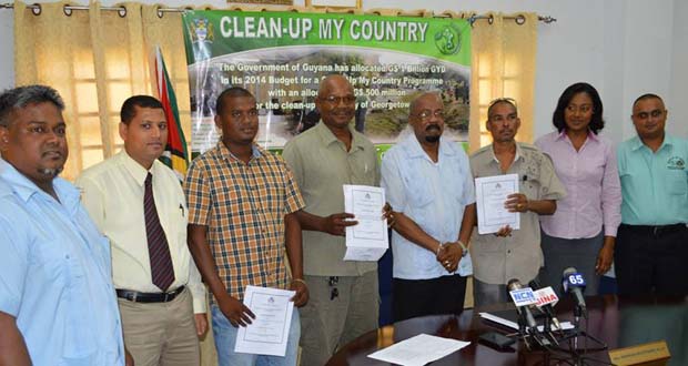 Permanent Secretary of the Ministry of Local Government and Regional development, Collin Croal, with Local Government Minister, Norman Whittaker and Public Relations Officer of the Local Government Ministry, Olive Gopaul with contract awardees and their representatives