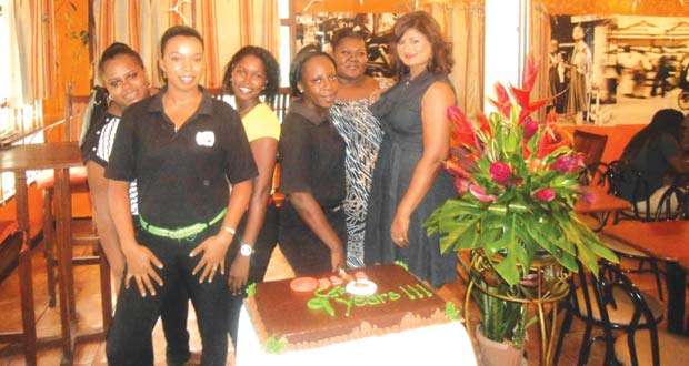 Staff alongside Nisa Walker (right) celebrate nine years of the Oasis Café service to Guyanese