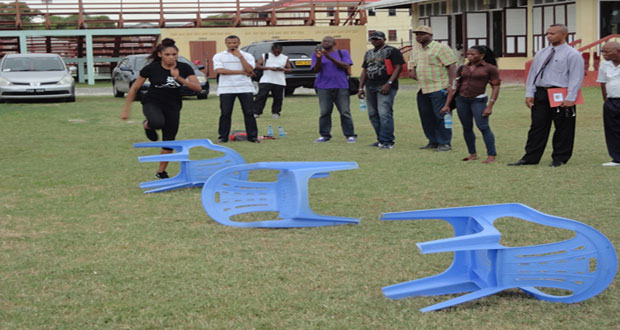 CASTLIN SHOWS: U.S. 100m hurdler Kristi Castlin demonstrates hurdle drills for coaches. Second right is AAG president Aubrey Hutson.