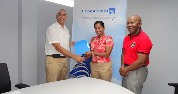 – Copa Airlines Country Sales Manager Nadine Oudkerk presents to David Gomes ‘A Letter of Commitment’ for their new partnership. At right is Director of Flex Night Inc. Donald Sinclair