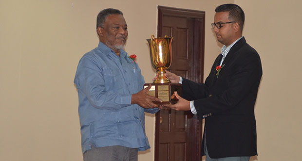 Prime Minister Samuel Hinds presents the President’s Award to Superior Shingles Wood Products’ representative, George Bulkan