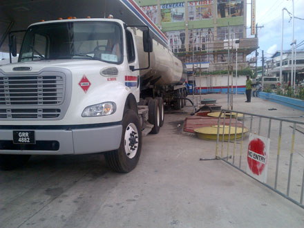 The fuel tanker delivers fuel into the underground tanks which feed the pumps at the Guyoil Service Station.