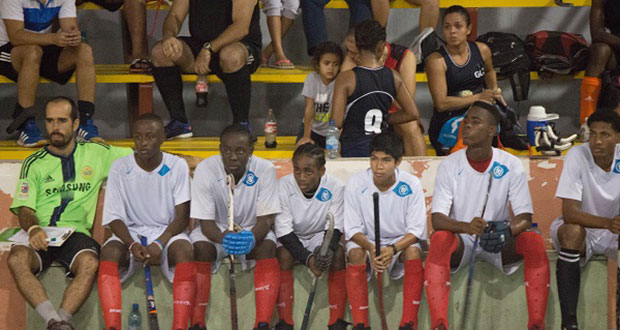 Head coach Robert Fernandes (L) and members of the National U-19 squad during the GT&T Indoor Hockey tournament.