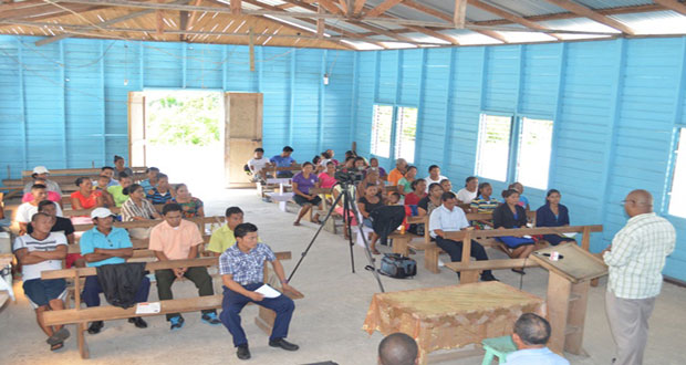 Minister within the Ministry of Finance, Bishop Juan Edghill, addressing residents at Assakata