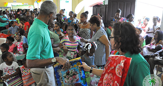 PNCR Leader David Granger and his wife distribute presents to children of Bartica
