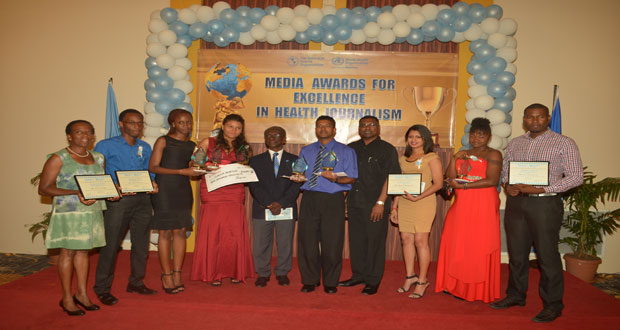 Media award recipients pose with PAHO representative, Dr. William Adu Krow and Chief Medical Officer in the Ministry of Health, Dr. Shamdeo Persaud