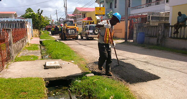 Workmen hard at it yesterday in the Middle Road La Penitence area (Photo by Ravin Singh)