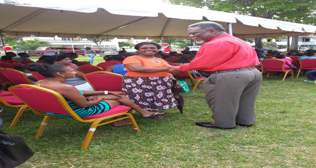 Prime Minister, Mr Samuel Hinds interacting with the folks who attended the annual Christmas party yesterday