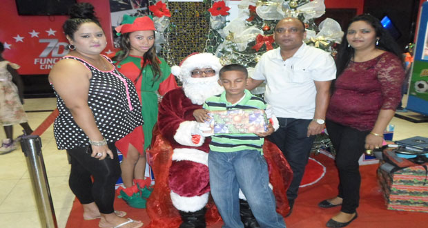 The Comfort Sleep family takes time out for a photo ‘op’ with Santa and a kid receiving his gift