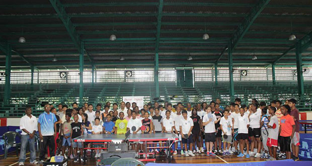 Digicel’s Gavin Hope, Minister of Sport Dr Frank Anthony, GTTA’s president Godfrey Munroe and National table tennis coach Linden Johnson (all in front row, seated) pose with all the school children at the closing ceremony of the Digicel-sponsored tournament.