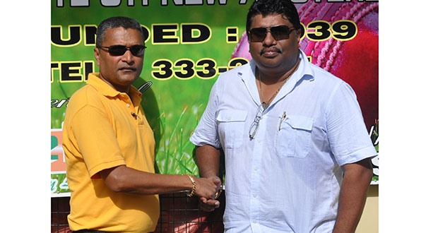 Let’s put our hands together and work to get the job done. Newly elected president of the Berbice Cricket, Board Anil Beharry (right), and secretary of the Guyana Cricket Board, Anil Sanasie, exchange pleasantries in front of the BCB office last Sunday.