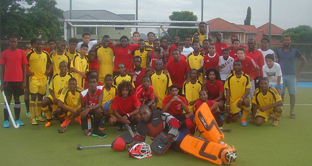 Guyana’s National Junior Men’s team in gold and the T&T Development U-19s after the game on Wednesday
