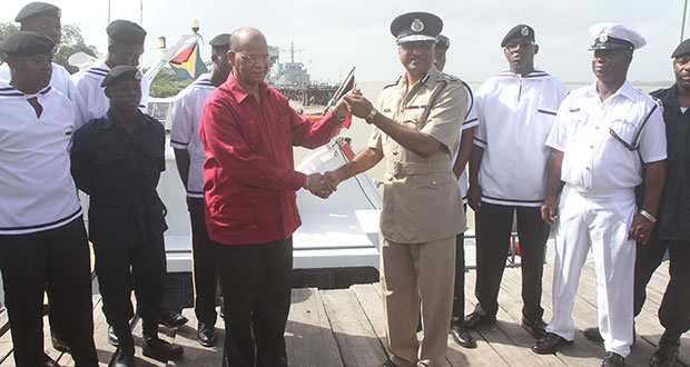 Acting Police Commissioner, Selall Persaud receiving the keys to one of the vessels from Minister Rohee in the presence of members of the Marine Wing of the GPF