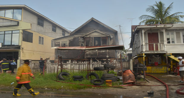The unpainted wooden house at centre was the one that was damaged by the fire