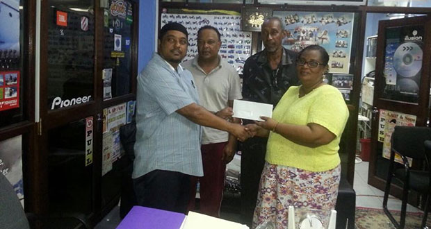 Managing Director of A. Ally and Sons Limited Faizal Ally makes the presentation of the cheque to secretary of the BCB Angela Haniff, while Leslie Solomon (left) and Carl Moore look on appreciatively.